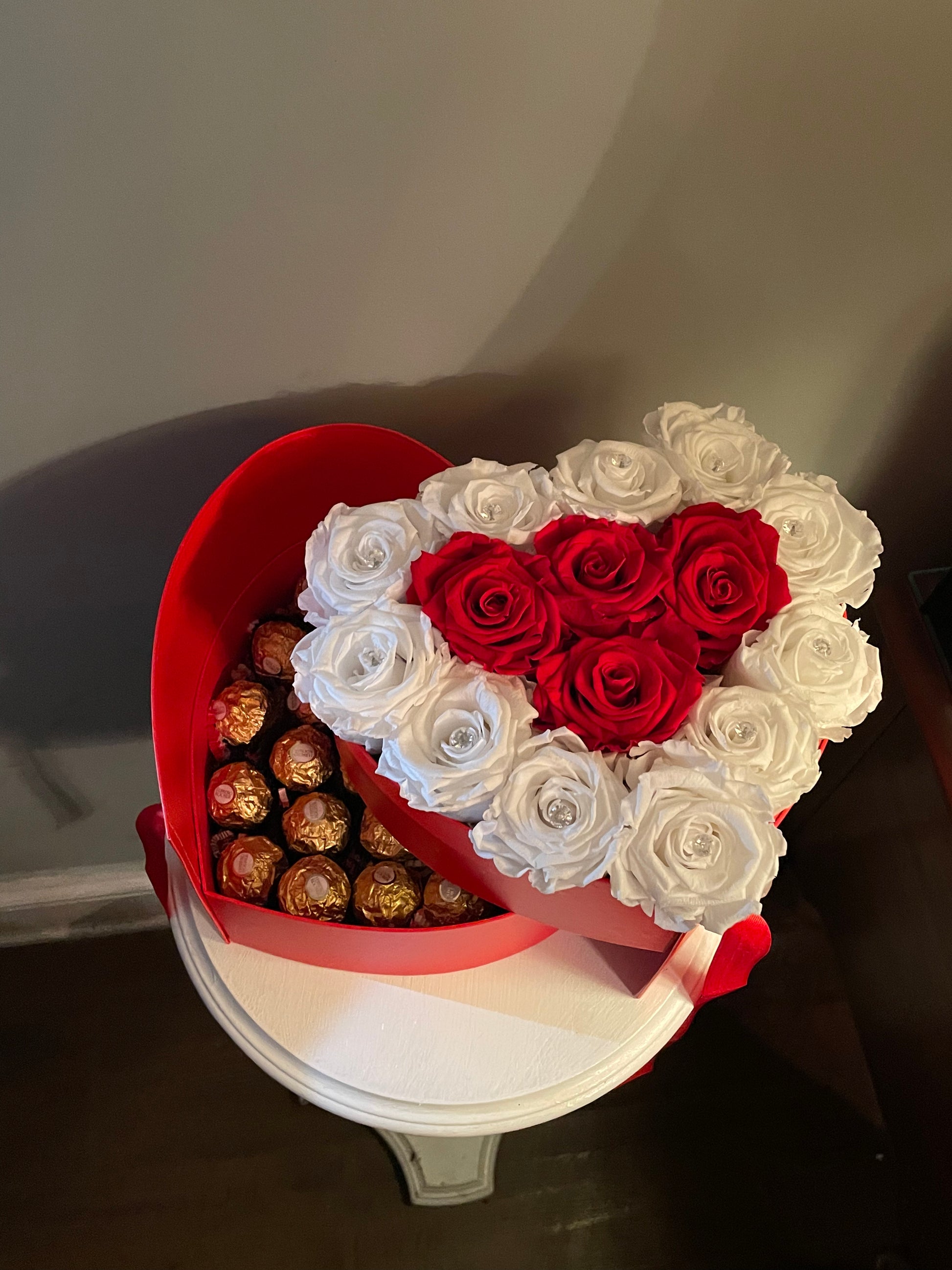 Heart-shaped box with roses and sweets